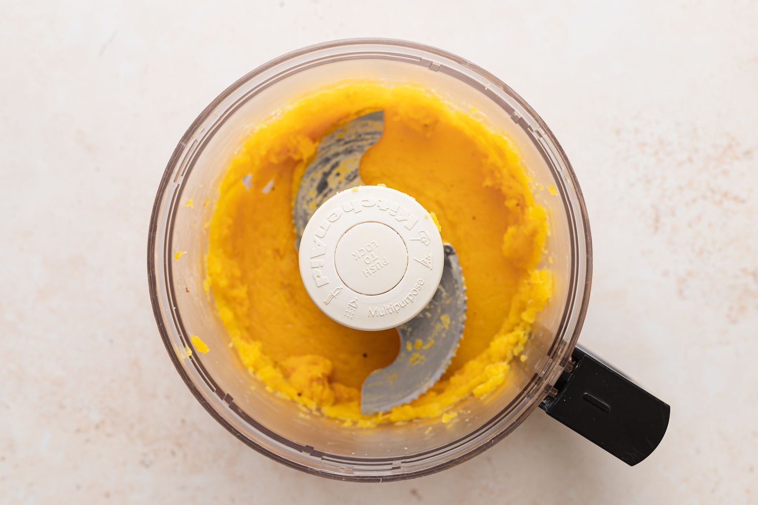 Squash pureed in a food processor to make vegan acorn squash.