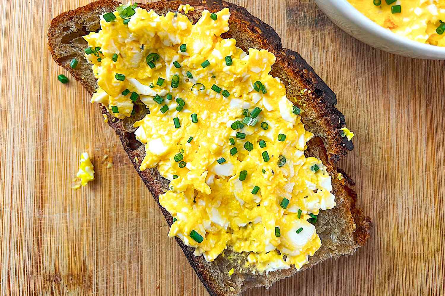 3-ingredient egg salad on toast next to a bowl with more egg salad 