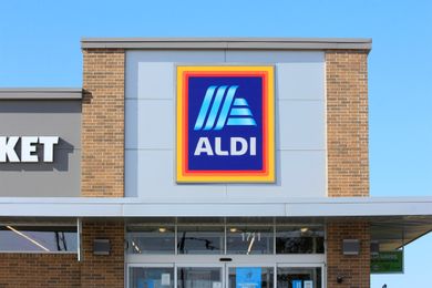 The front facade of an Aldi store with its sign prominently displayed and part of the entrance visible