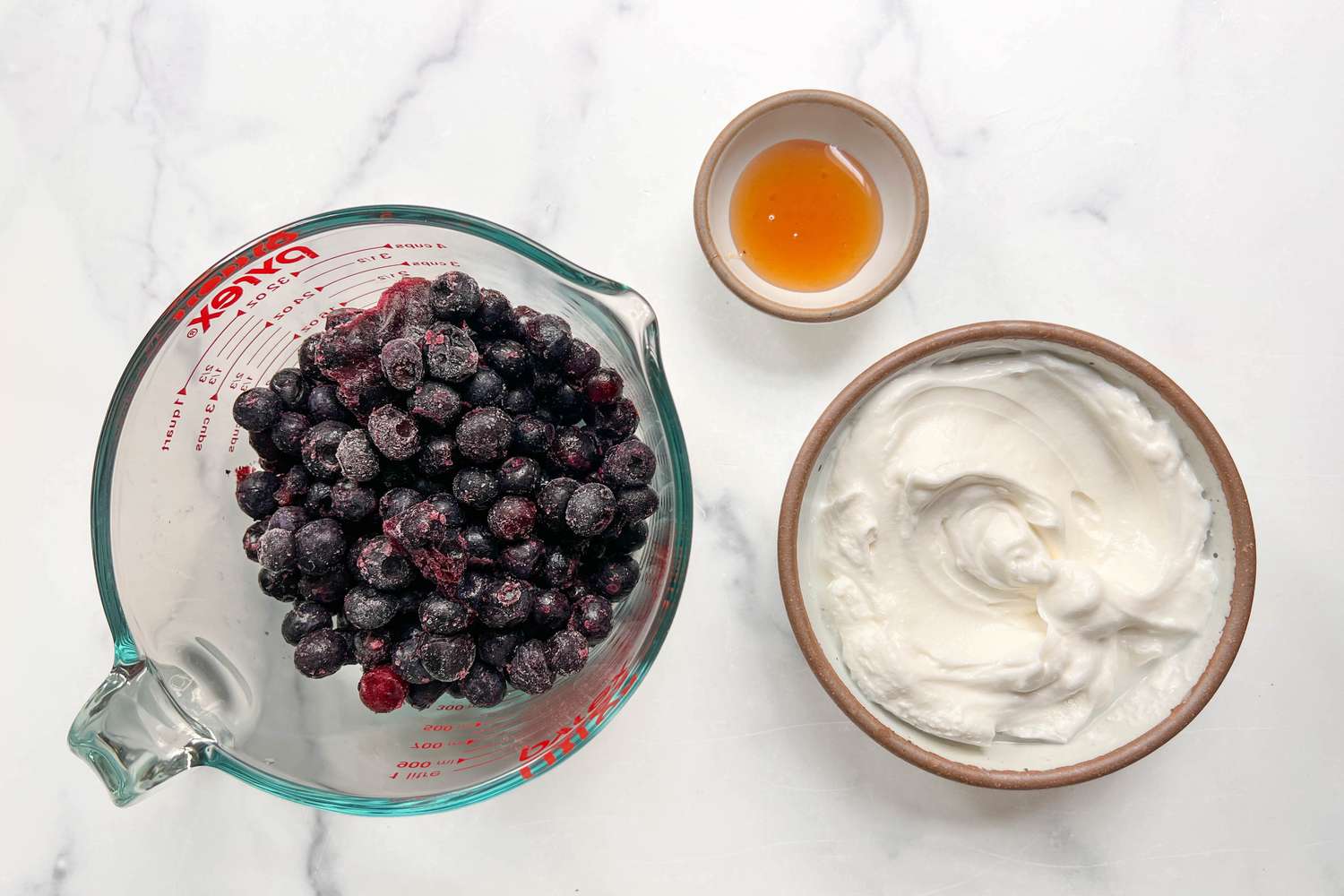 Frozen blueberries, Greek Yogurt. and honey