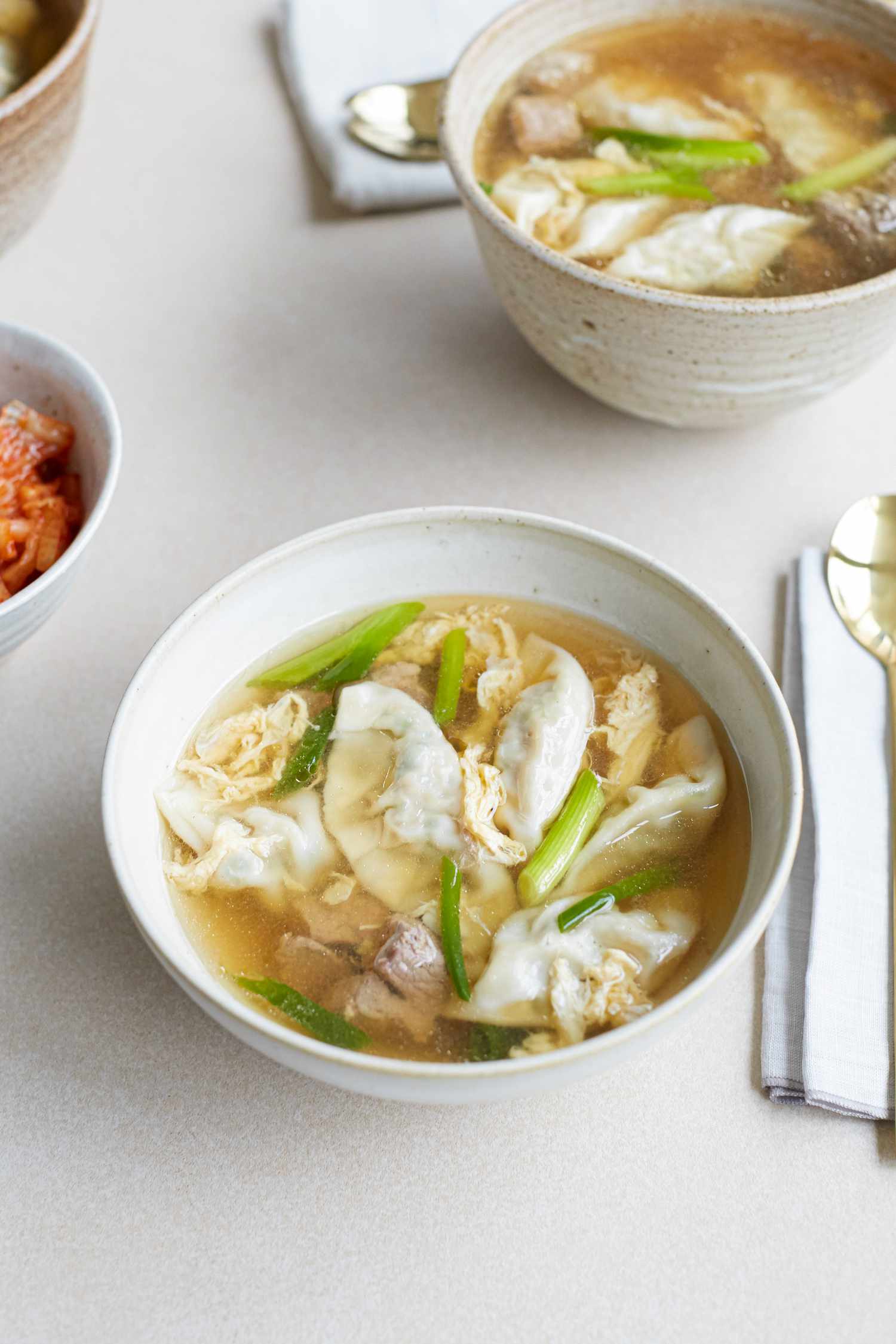 Overhead view of a bowl of beef soup with dumplings.