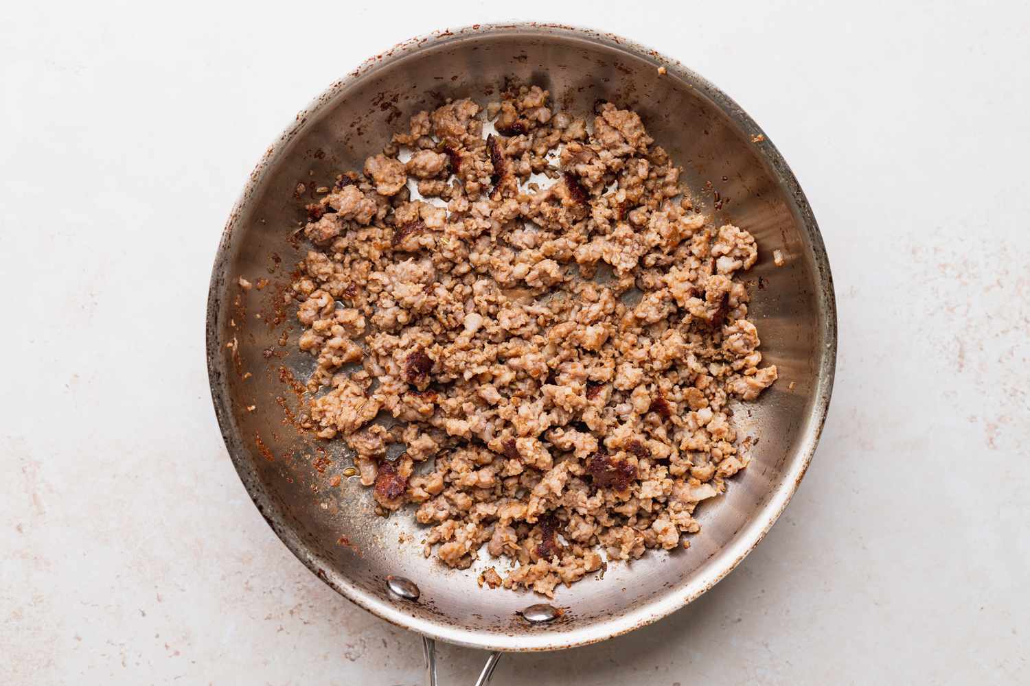 Browned sausage in a pan to make baked spaghetti