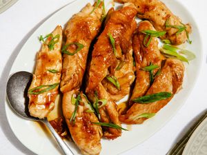 hot honey tenders on a platter with a serving spoon