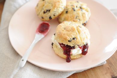 Traditional Irish Scones on a plate and spread with jam.