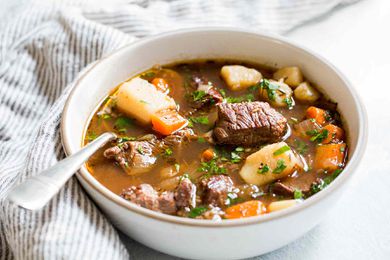 Irish stew with beef, carrots, and potatoes, Guinness and wine served in a bowl