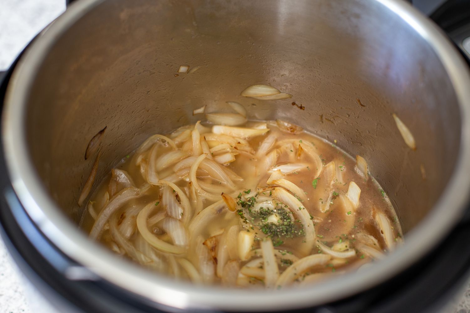 Sauteed onions in an instant pot to make quick and easy instant pot turkey breasts.