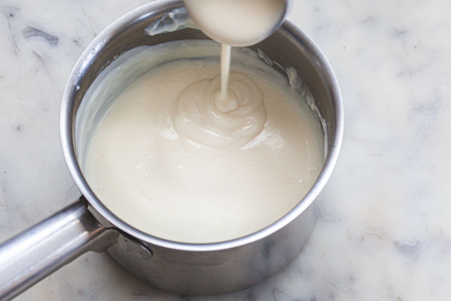 Béchamel sauce (white sauce) in a pan.