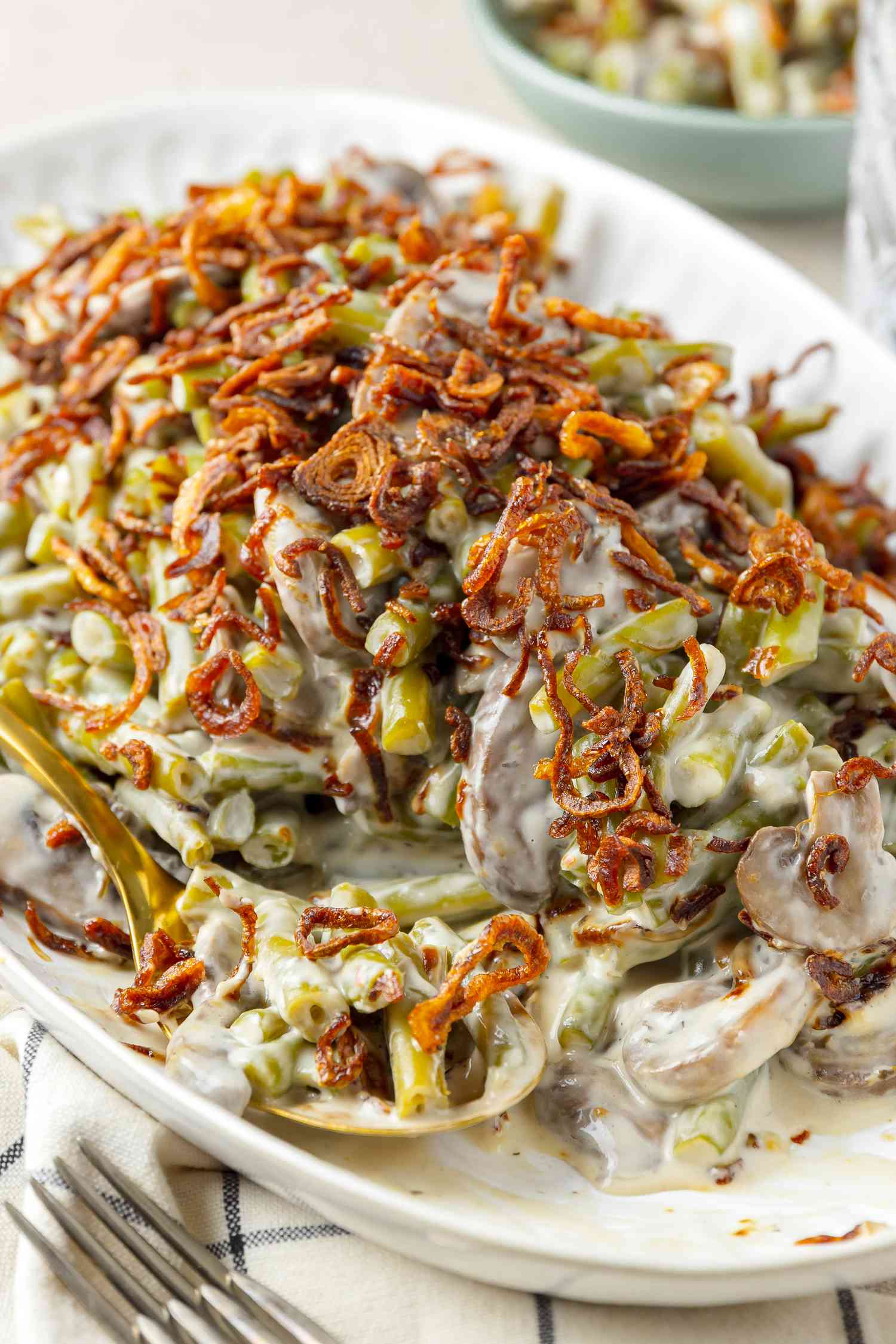 Slow Cooker Green Bean Casserole on a Platter with Some on a Spoon