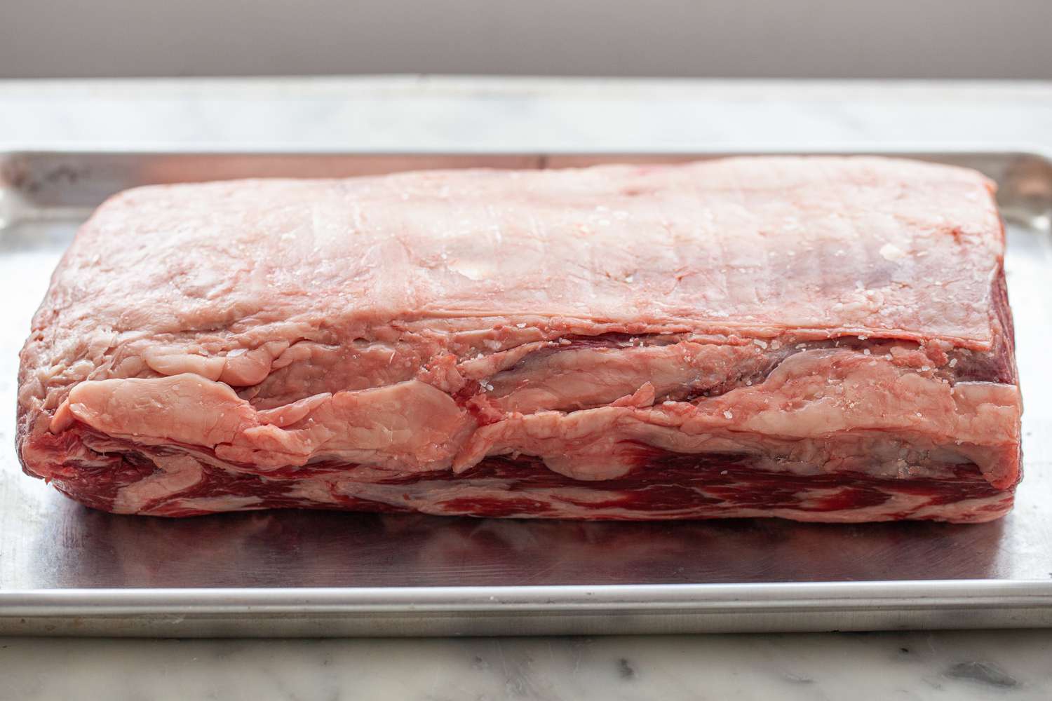 Prime rib on a baking sheet to make Herb butter prime rib with gravy.