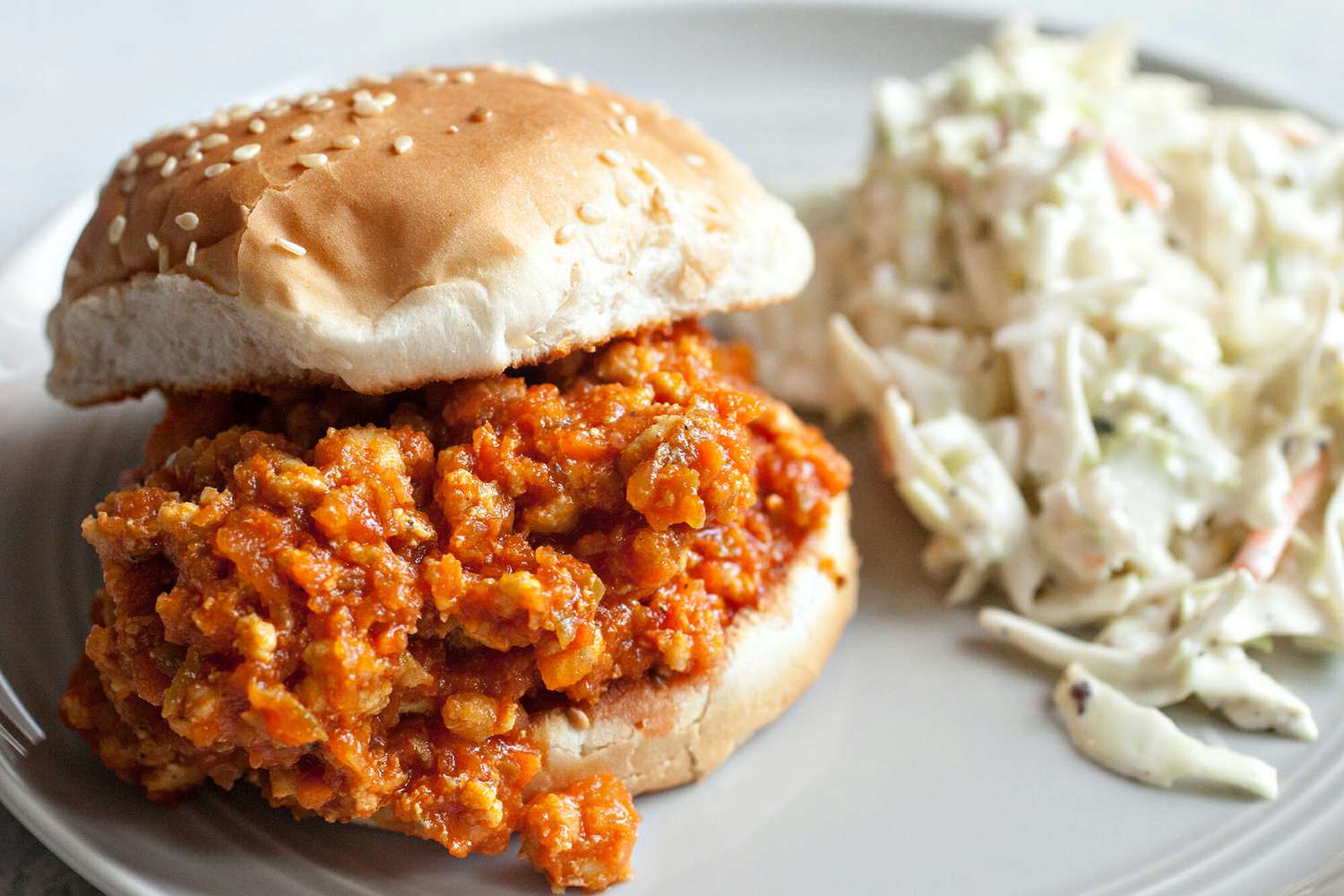 turkey sloppy joe on a roll with side of cole slaw