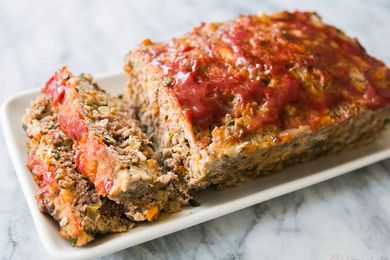 Meatloaf with a ketchup glaze on a rectangular serving platter