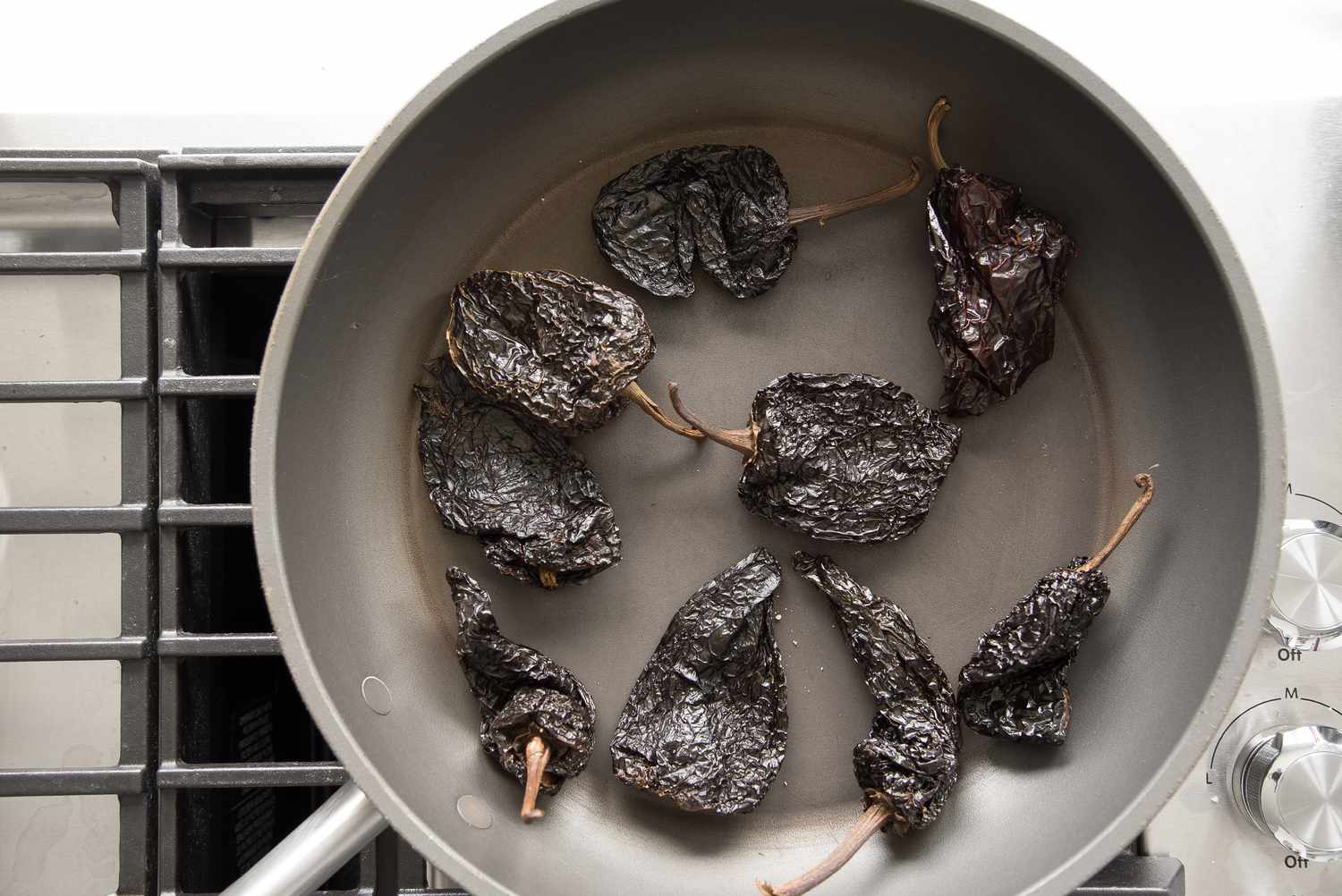 Ancho Chiles Toasted on a Skillet on the Stove for Red Enchilada Sauce Recipe