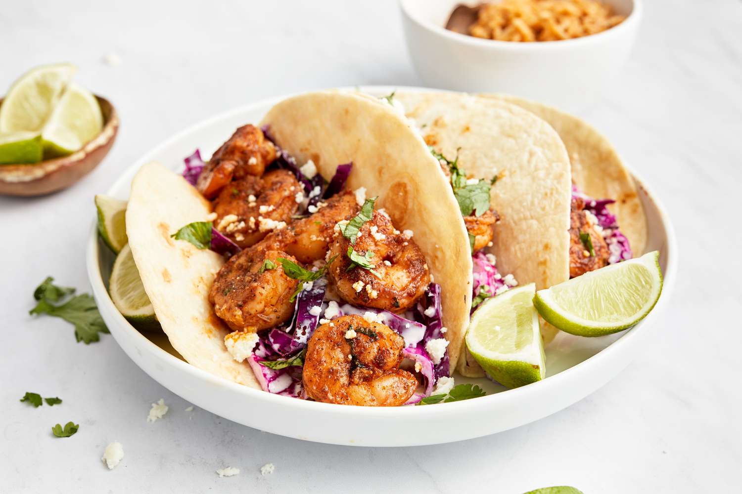 Blackened Shrimp Tacos and Lime Wedges on a Plate