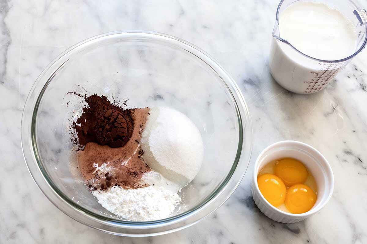 Ingredients to make a Chocolate pie filling separated in bowls.