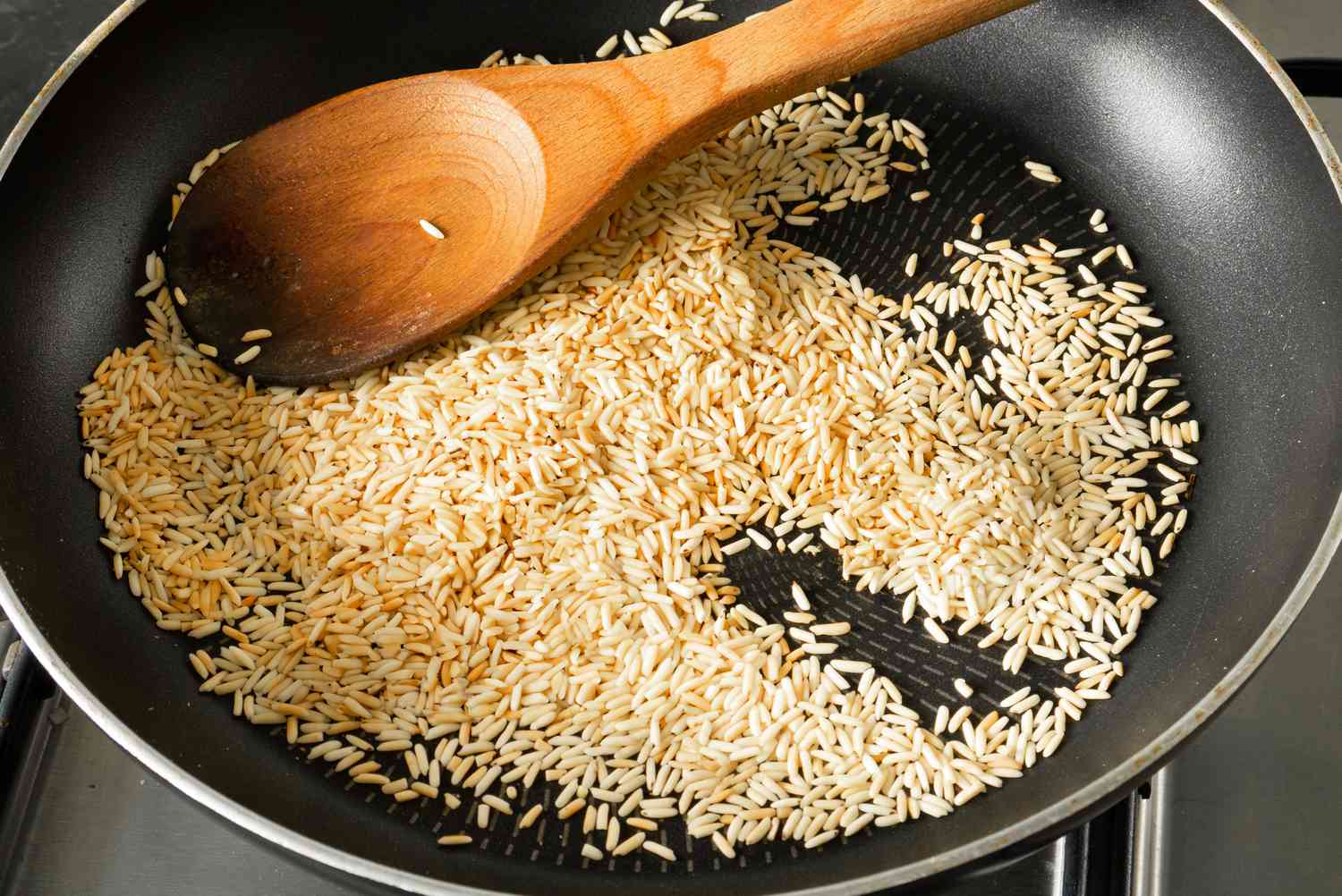 Rice getting toasted in a nonstick pan