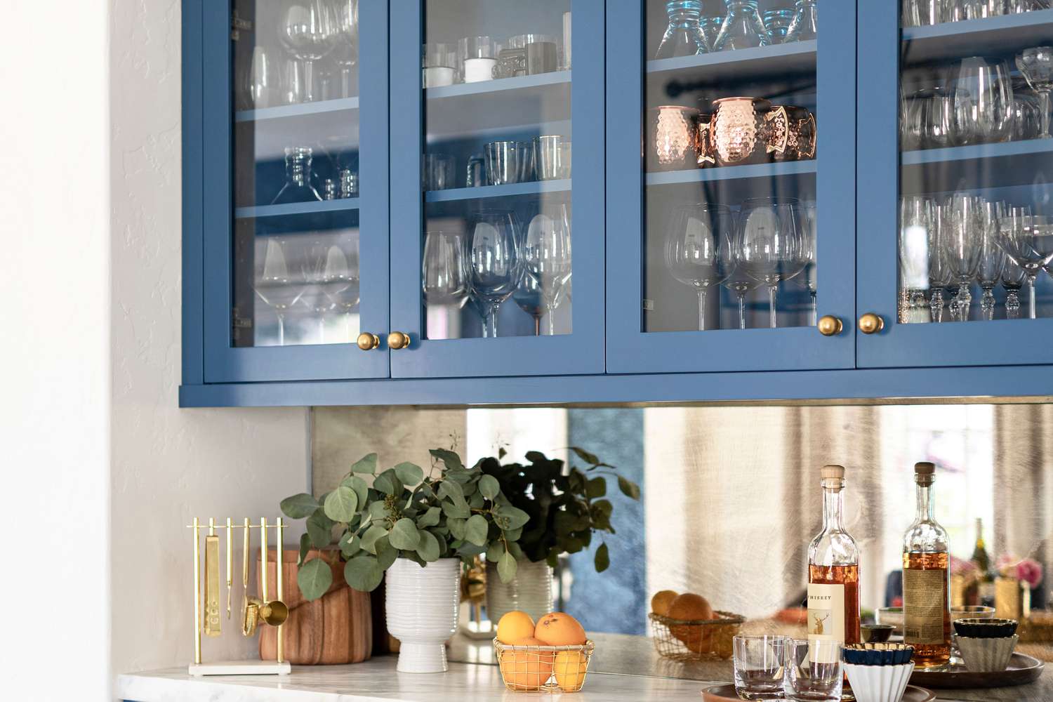 cabinets with glass doors, cups and glasses all stored neatly inside