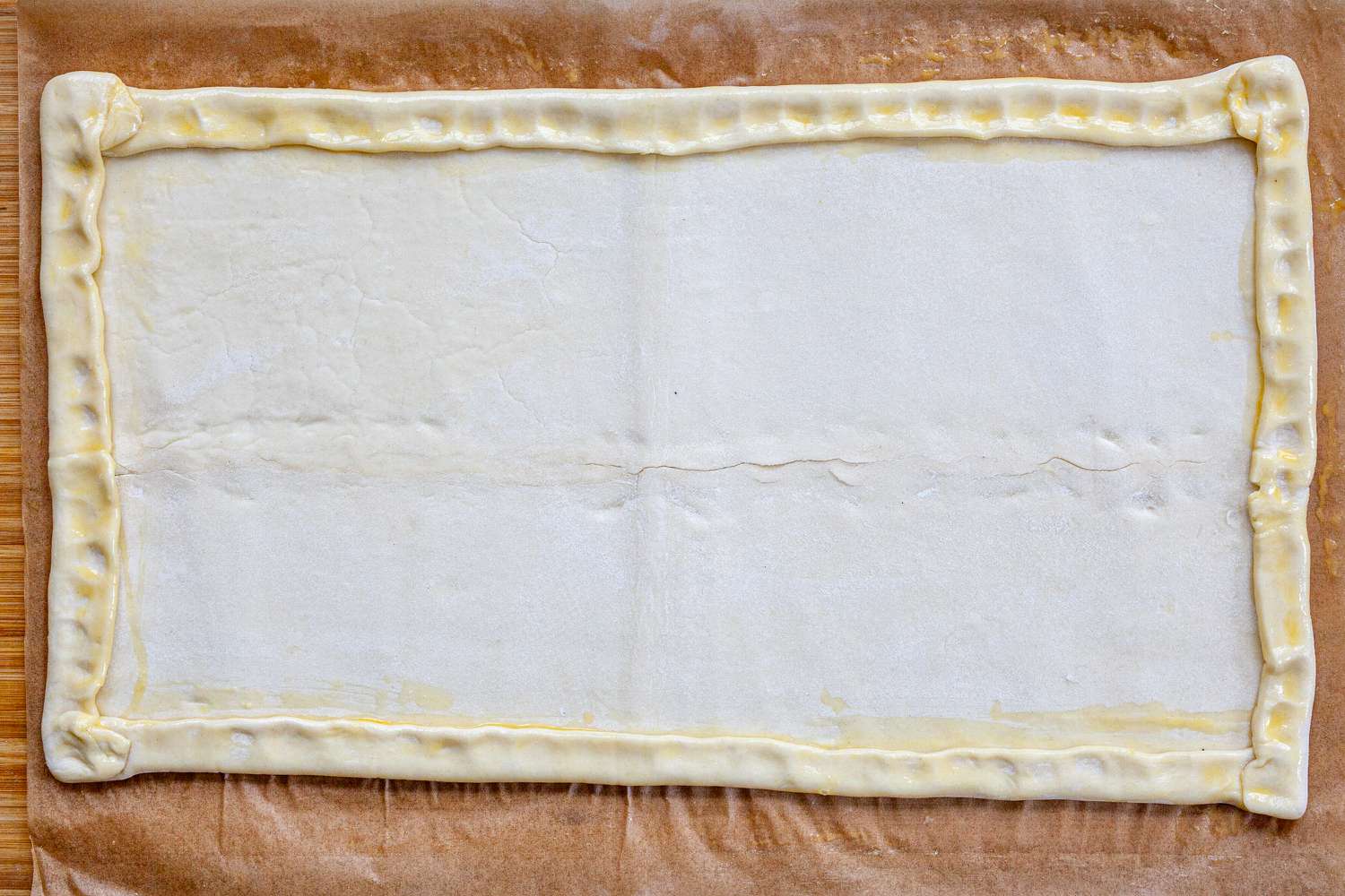 Puff pastry with the sides folded to make a Spring Asparagus Tart.