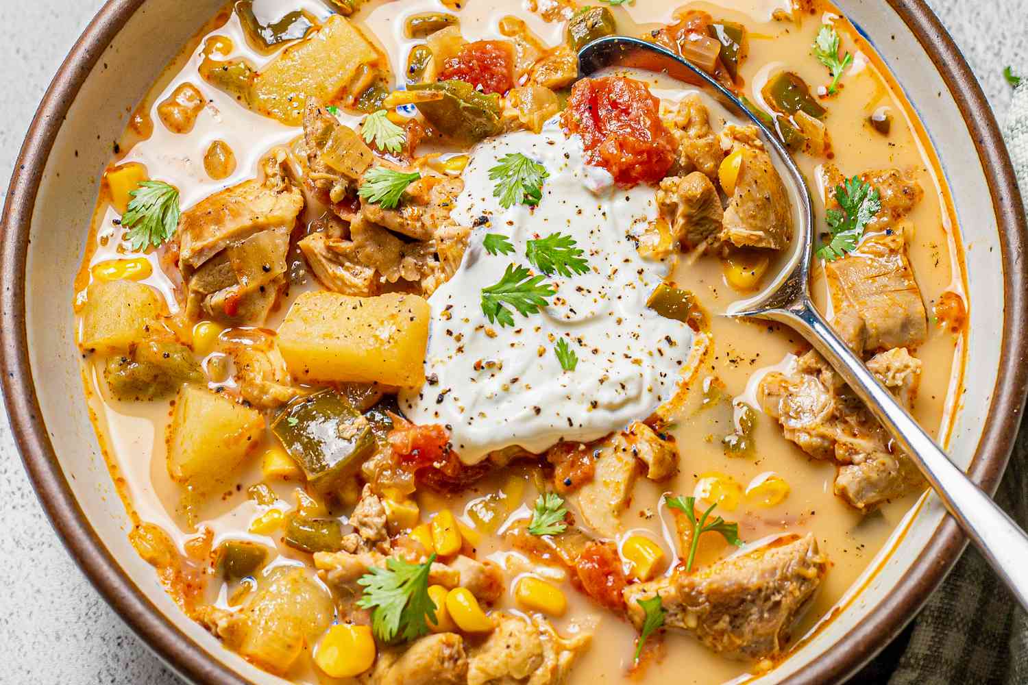 Chipotle Chicken Chowder Garnished with Sour Cream and Cilantro