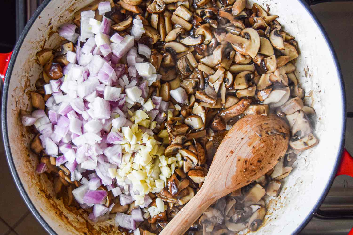 Dice Onions and Garlic Added to Sautéed Mushrooms in a Dutch Oven