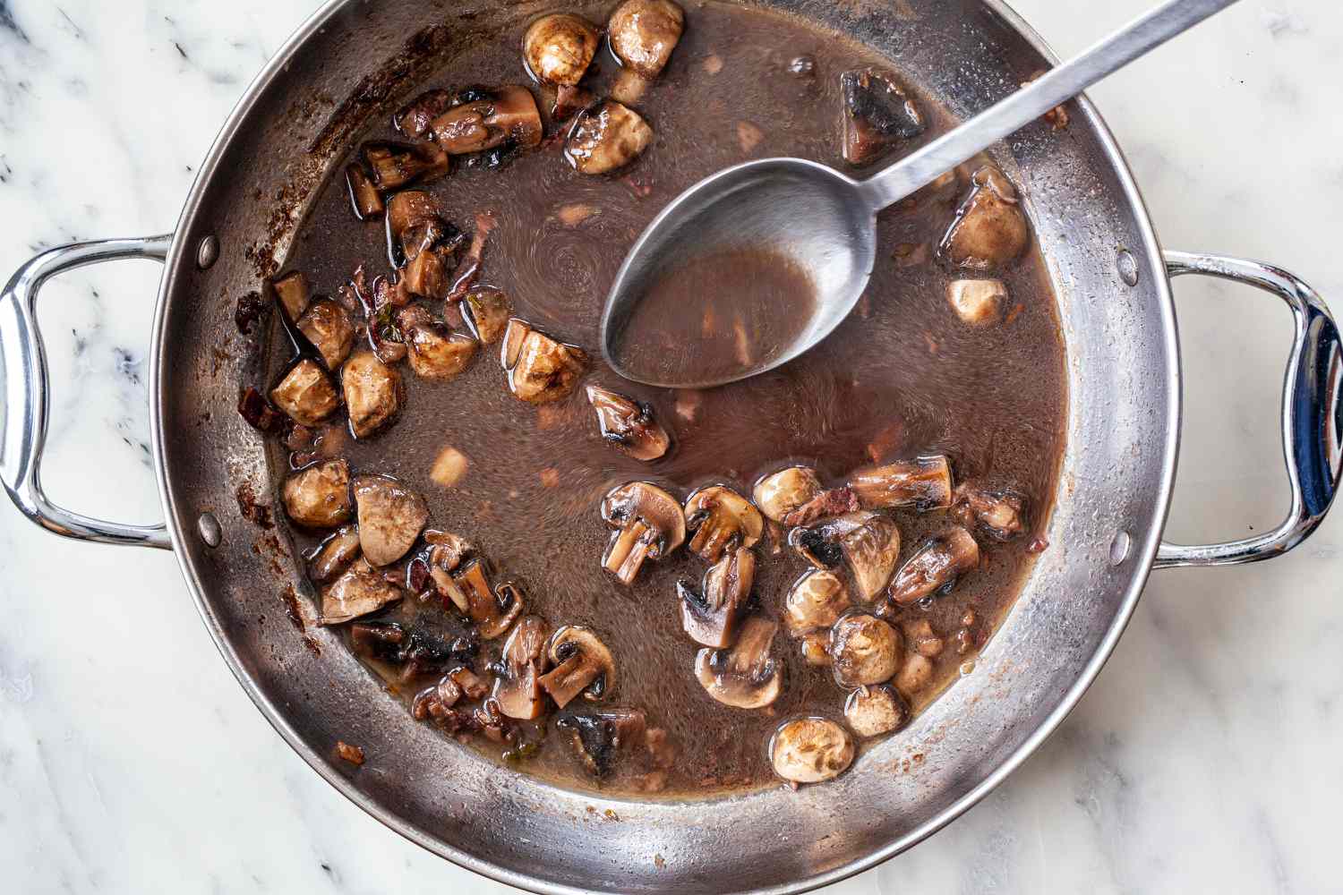 Coq au vin sauced reduced in a stock pot.