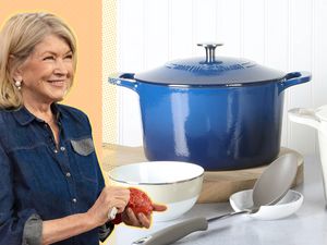 Martha Stewart peeling a tomato next to a bright blue Dutch oven