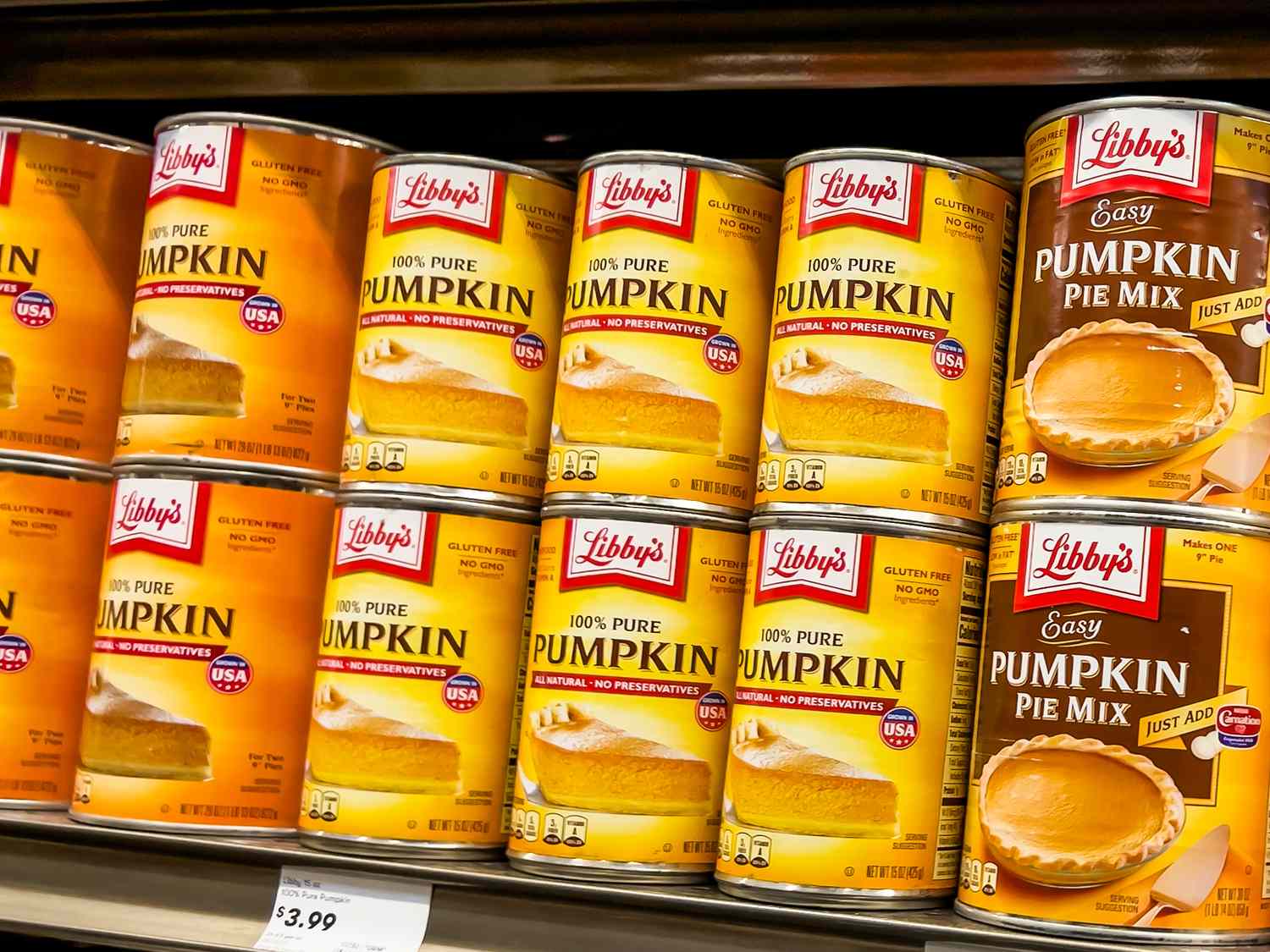 Cans of Libbys pumpkin puree and pie mix displayed on a store shelf