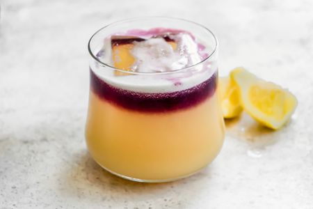 New York Sour Cocktail Next to Some Lemon Wedges