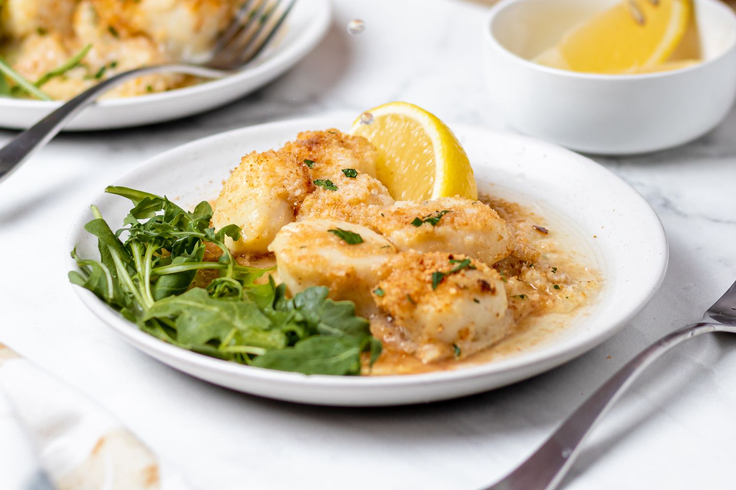Baked scallops with breadcrumbs on a plate