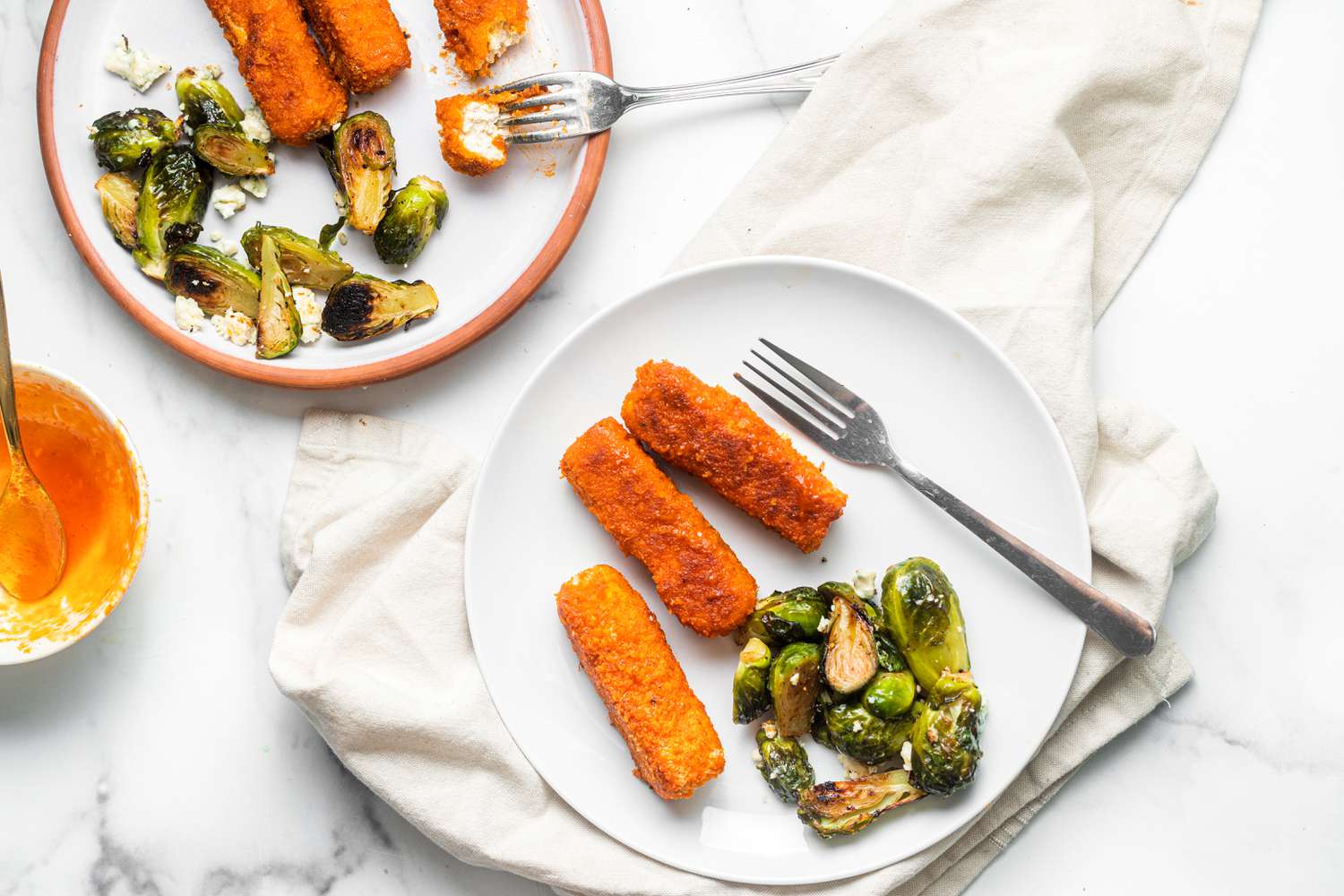Sheet Pan Buffalo Tofu and Blue Cheese Brussels Sprouts on Two Plates