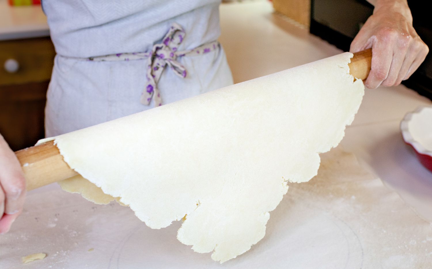 Pie Dough Rolled onto Rolling Pin and Lifted to Move Pie Dough to a Pie Dish