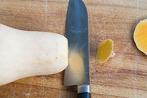 Butternut squash with top cut off by kitchen knife