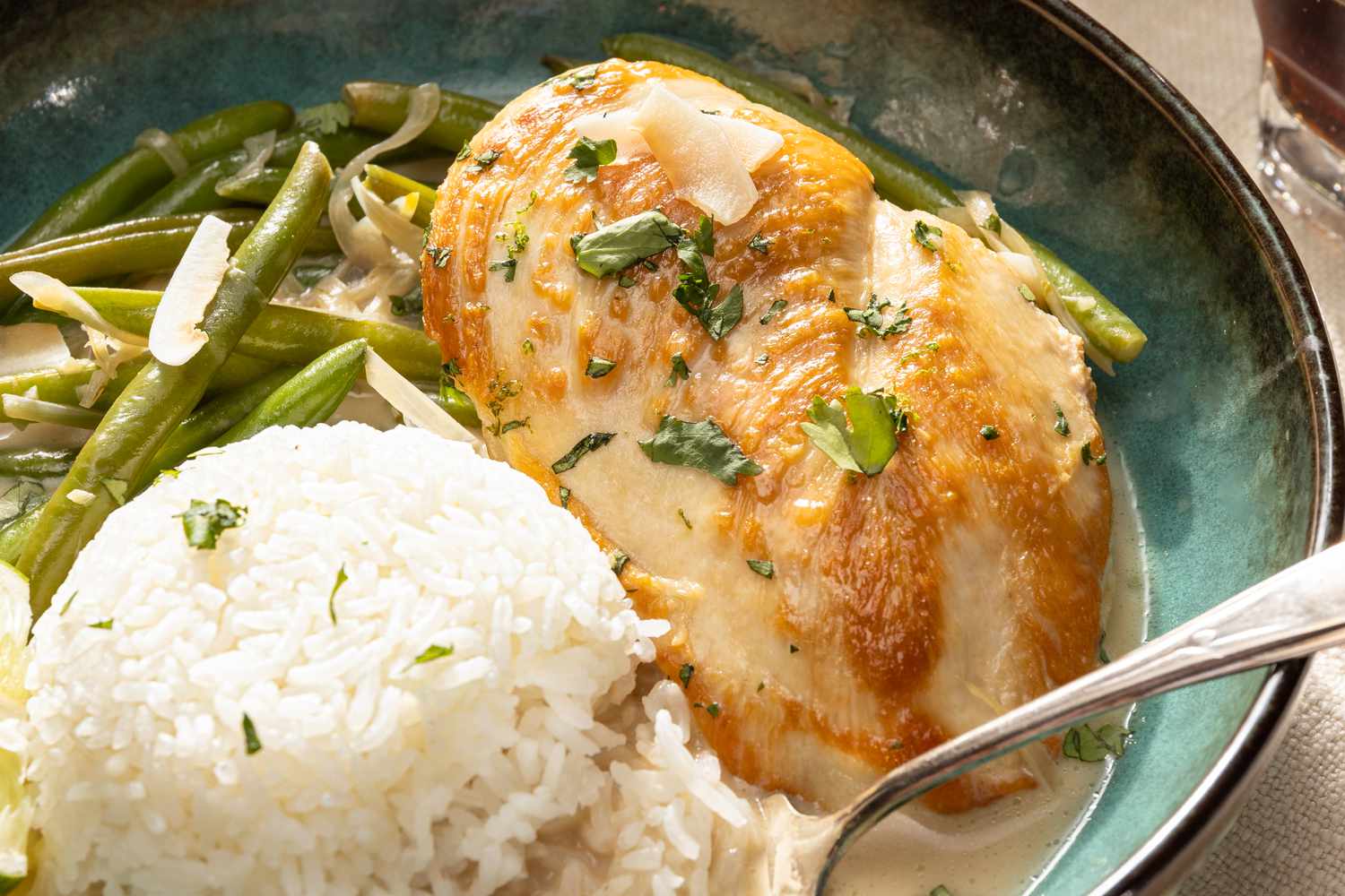 close-up: coconut lime chicken on a plate with rice
