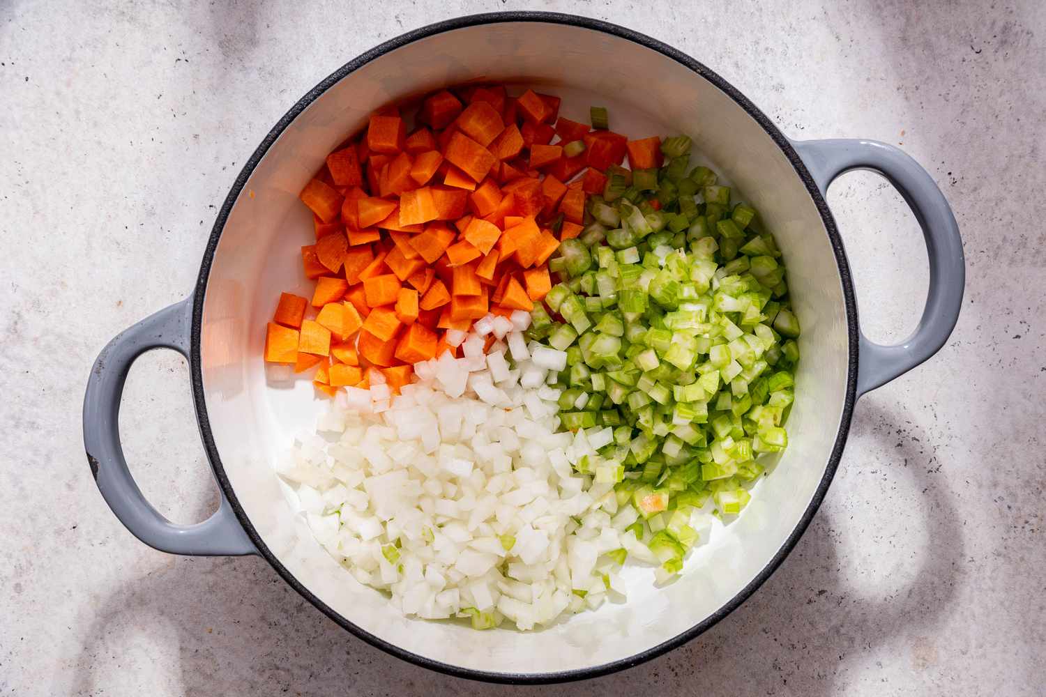 Chopped stock vegetables in Dutch oven for creamy vegetable dumpling soup recipe