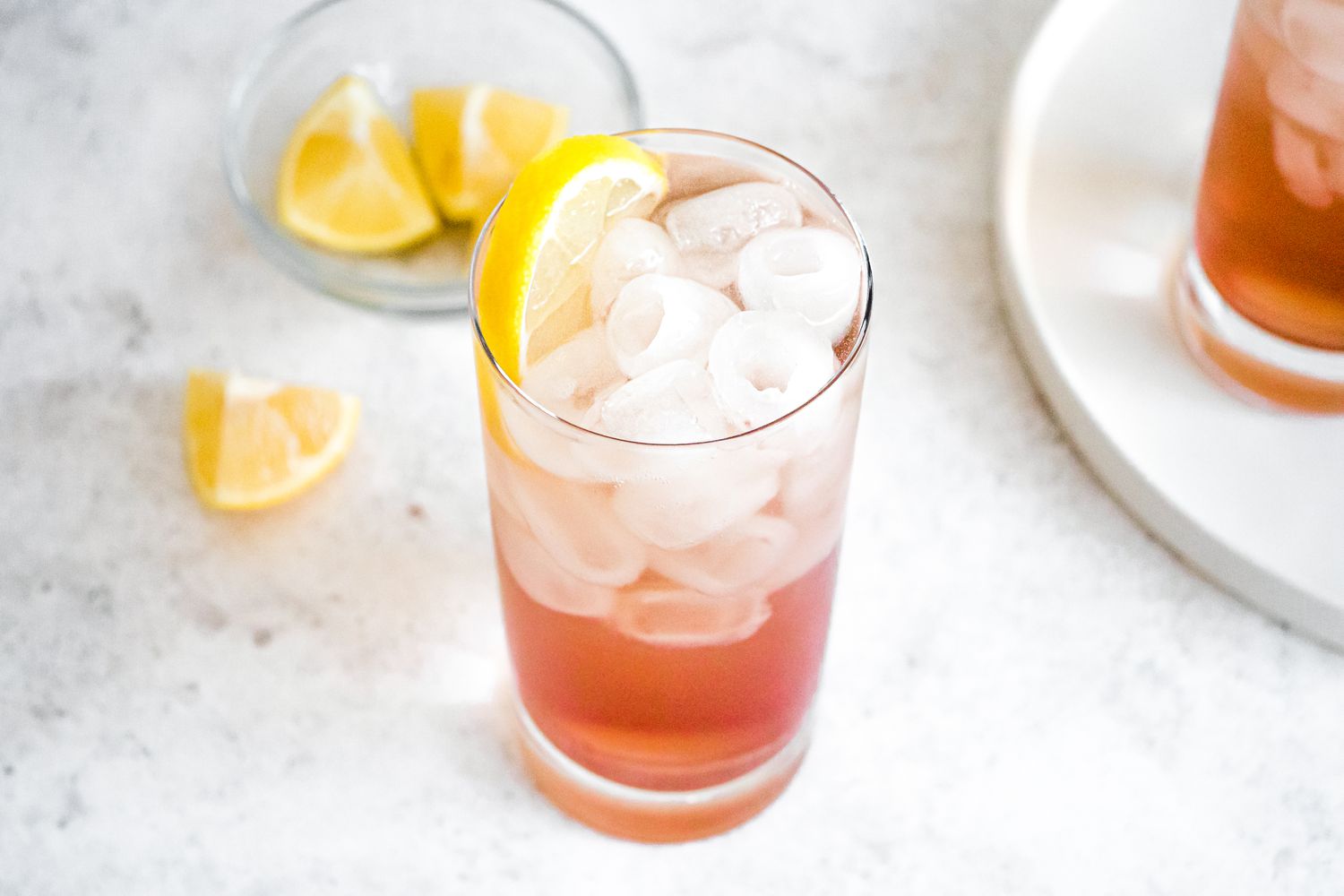 Sloe Gin Fizz in a Glass with Ice and Lemon Slice