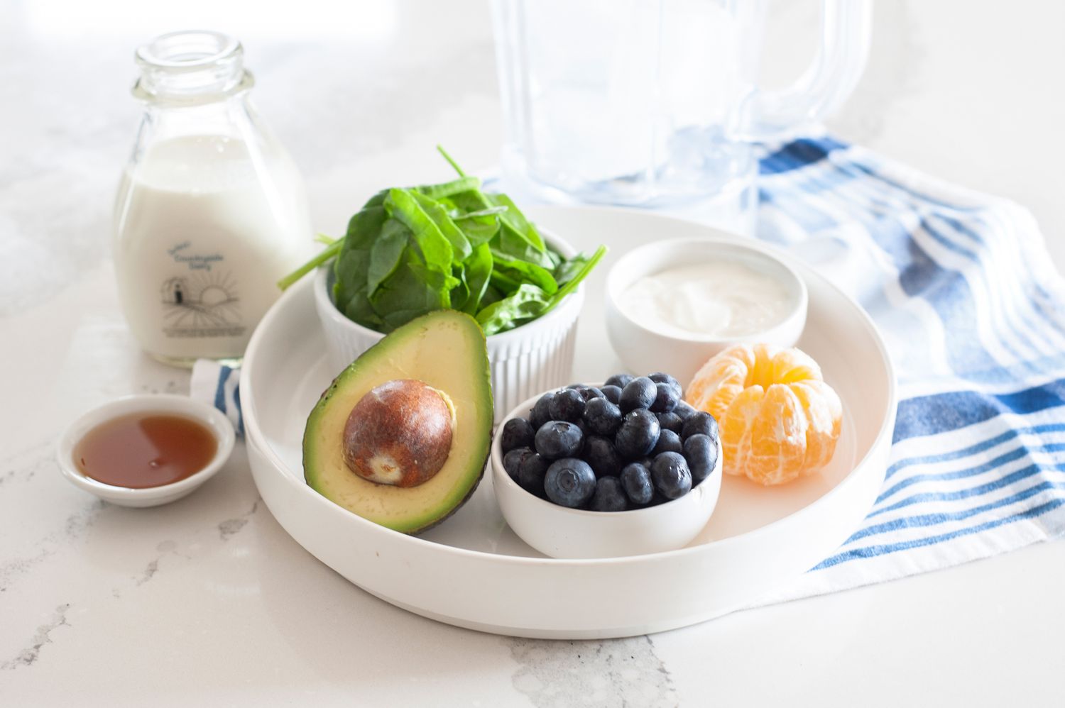 Ingredients on a tray to make a blueberry smoothie recipe.