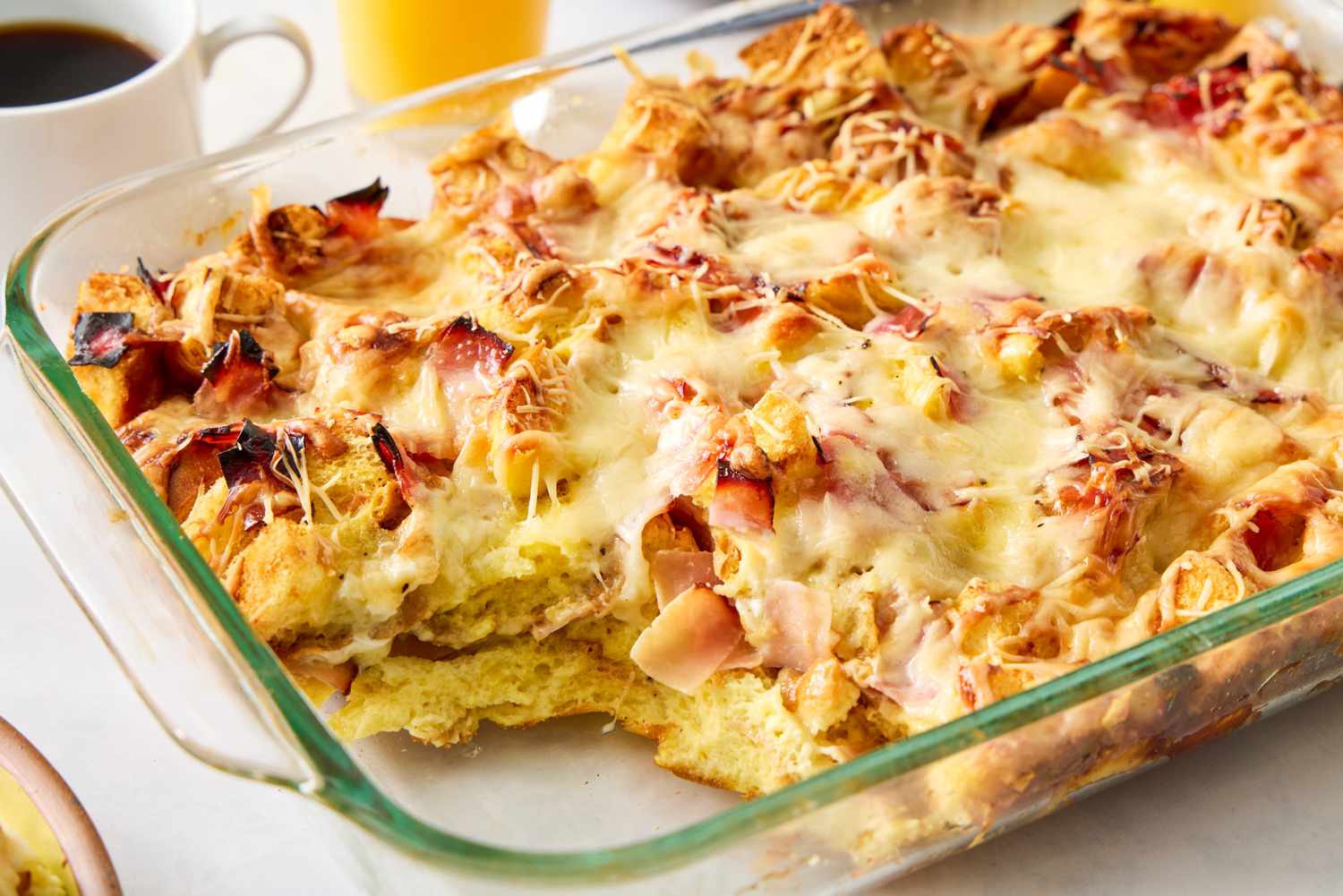 Dish of baked croque monsieur casserole with cheese and bread visible