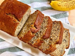 Overhead view of simple gluten-free banana bread on a platter and sliced into thick slices.