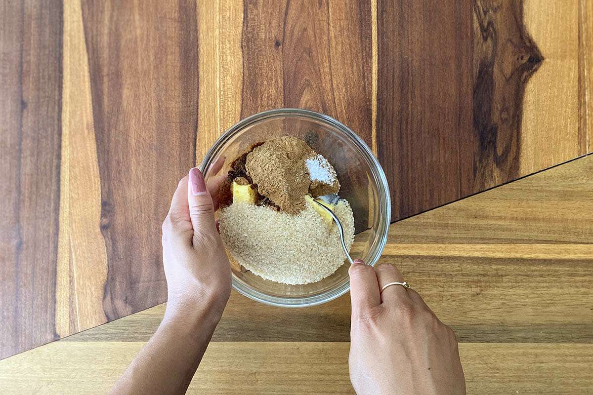 A small glass bowl has ingredients for the filling for easy gluten free cinnamon rolls.