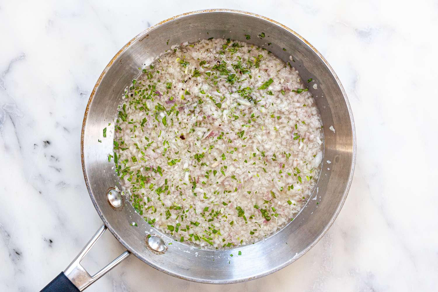 Toasting aromatics in a skillet to make béarnaise sauce.