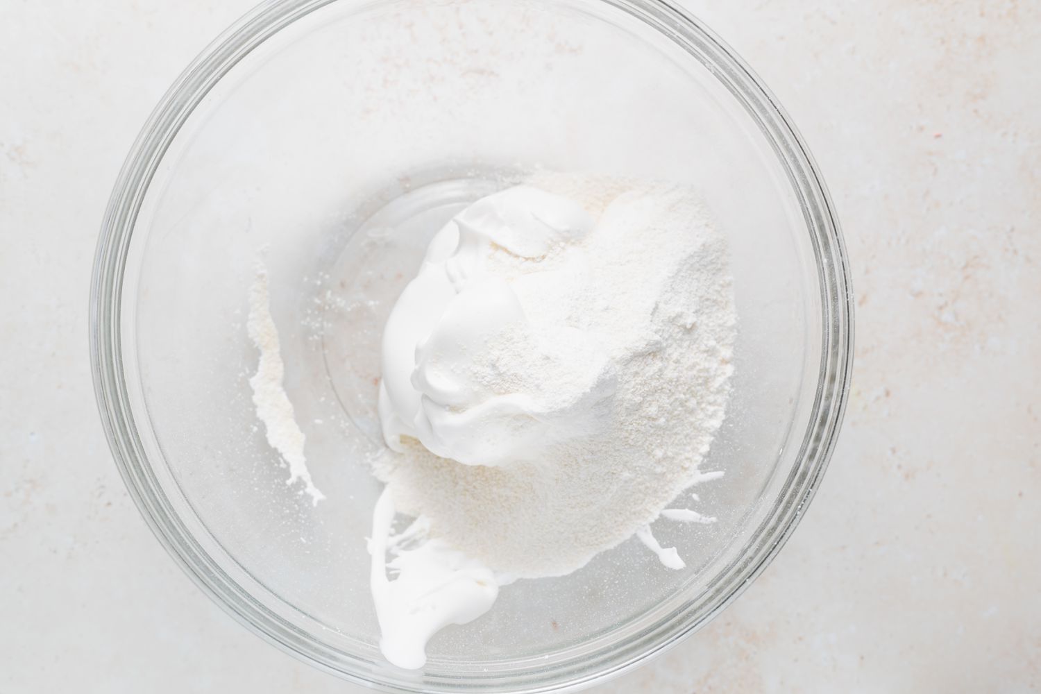 Whipped ingredients to make French macarons with peppermint white chocolate filling