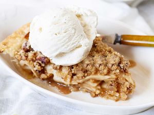 Single slice of easy dutch apple pie with a scoop of ice cream