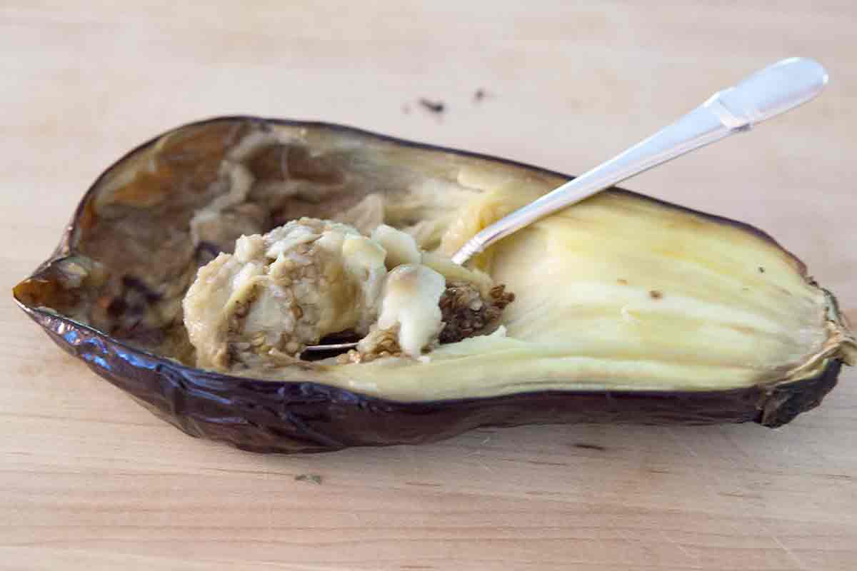 scoop out cooked eggplant for baba ganoush dip