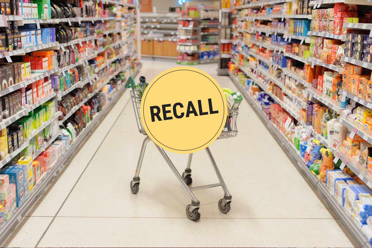 A grocery store aisle with a full shopping cart in the middle and a "Recall" badge overlaid
