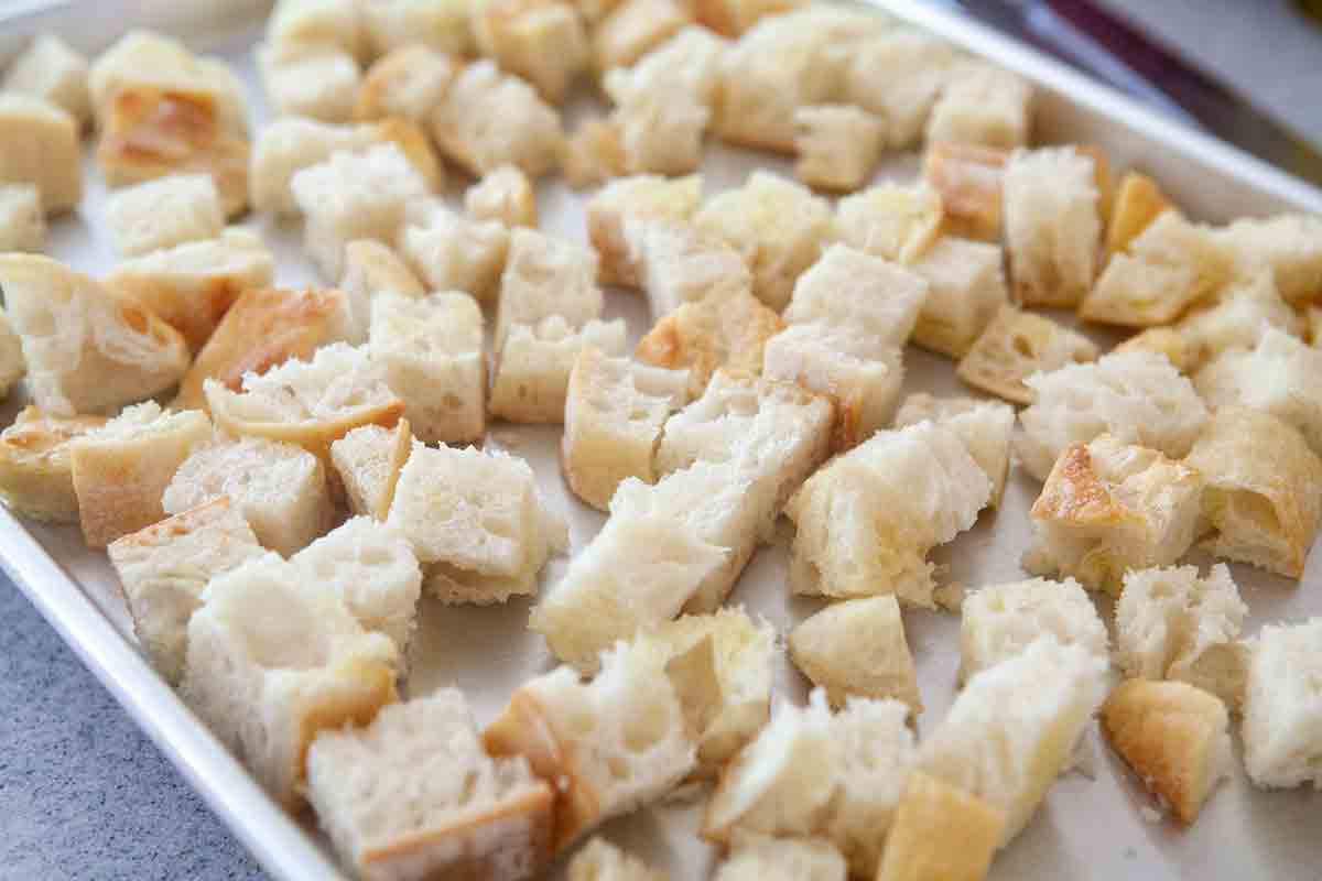 cubed bread on baking sheet
