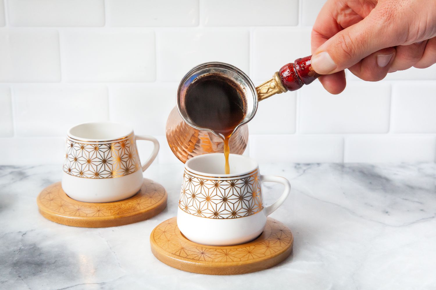 Turkish Coffee Poured into a Cup on a Coaster from a Cezve 