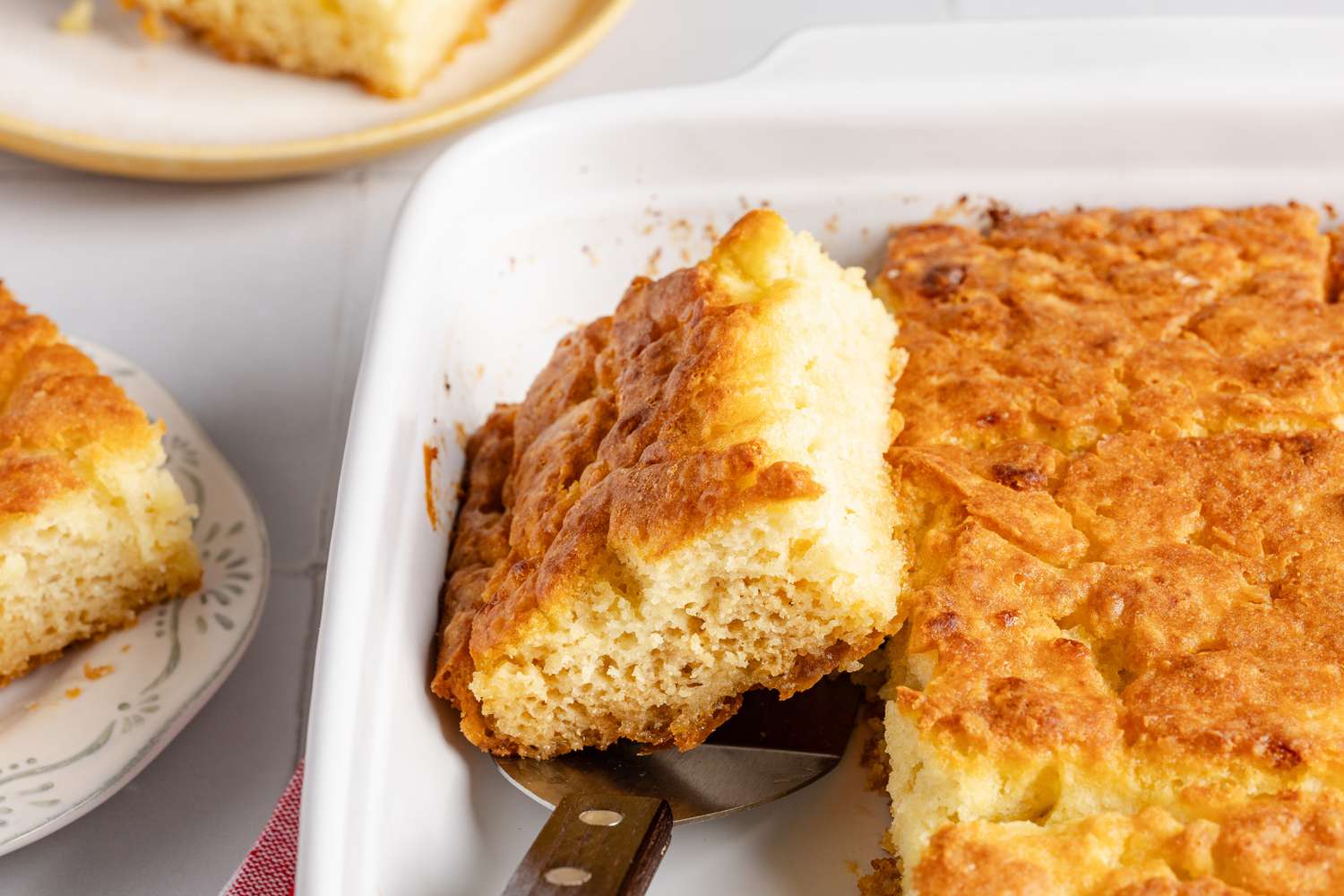 A butter swim biscuit in the pan on top of a spatula