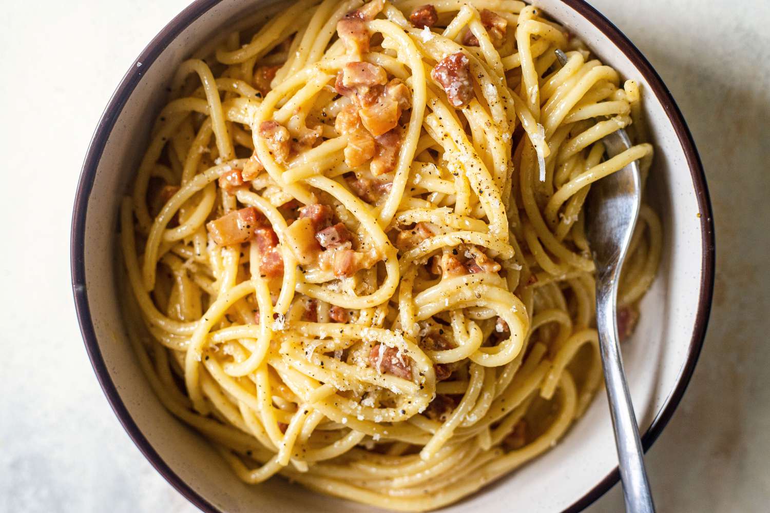 Spaghetti Carbonara in a bowl with a fork