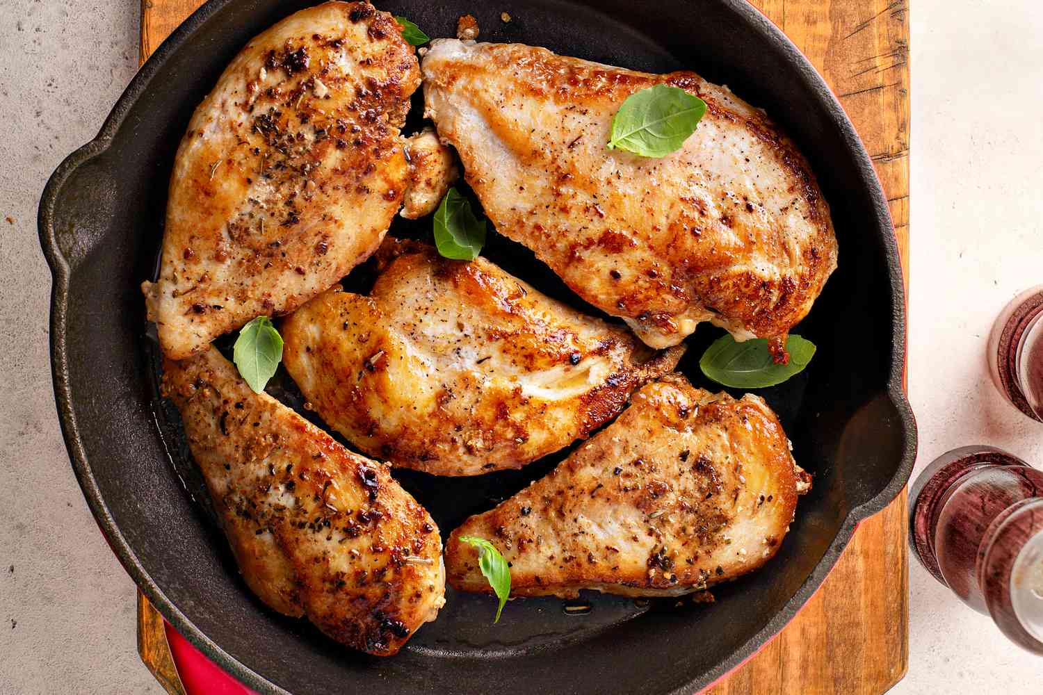 cooked seasoned chicken breast in a cast iron skillet