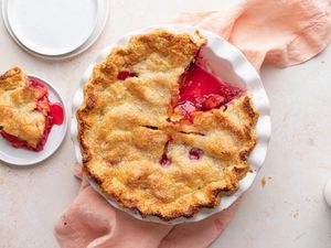 Overhead view of a summer peach and raspberry pie.