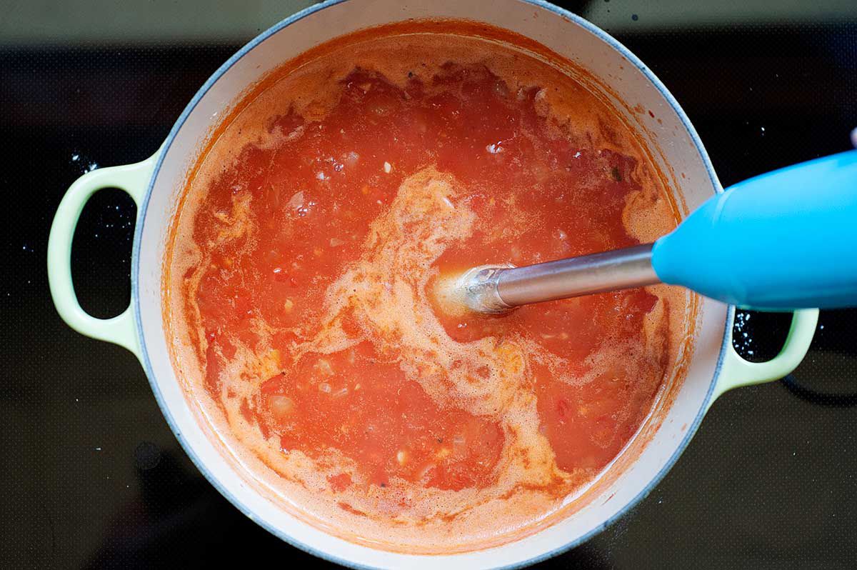 Homemade Tomato Soup - tomato soup in a dutch oven with an immersion blender